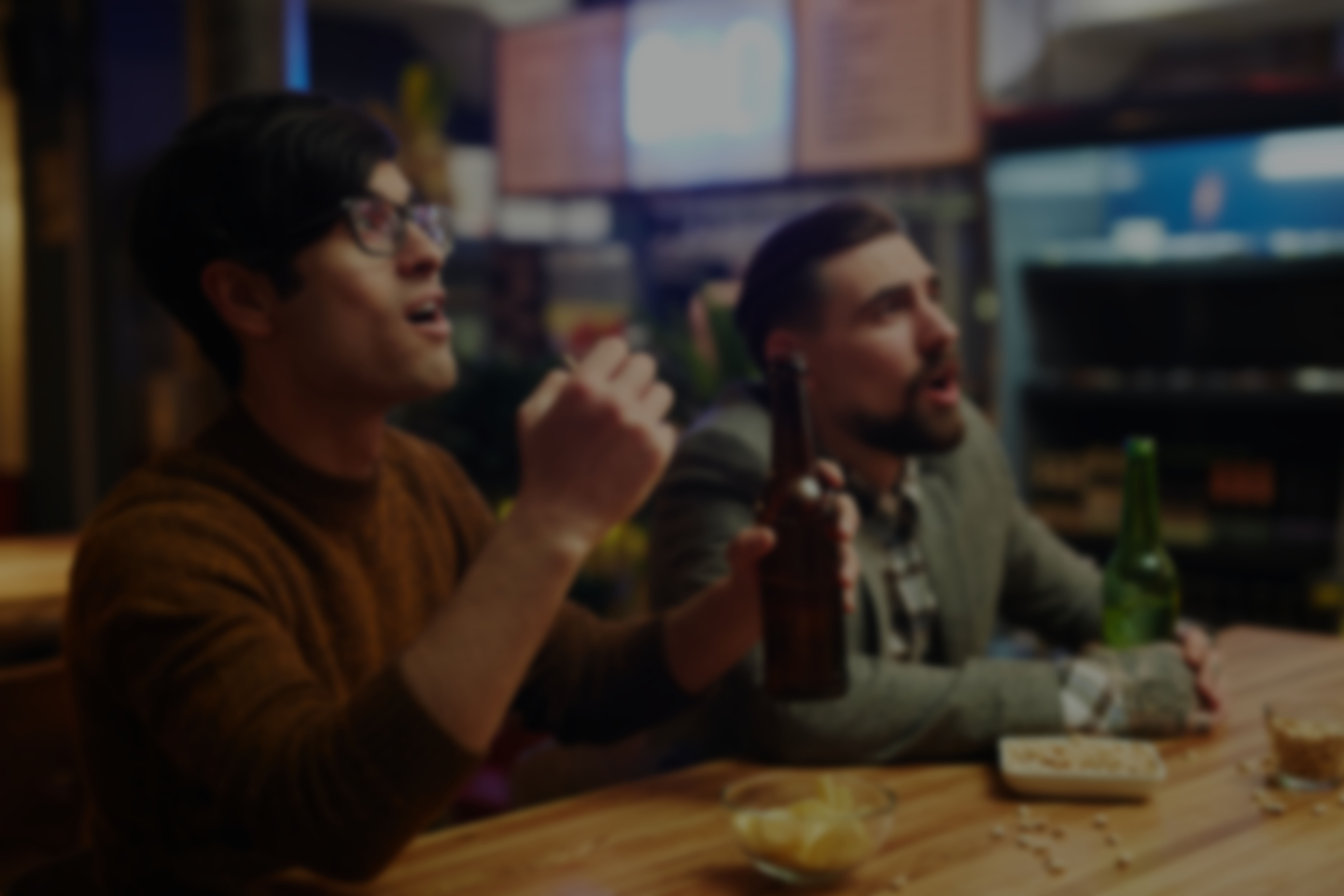 people cheering at a bar